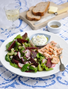 Summer garden salad with beetroot, celery and trout fillets. horseradish cream dressing